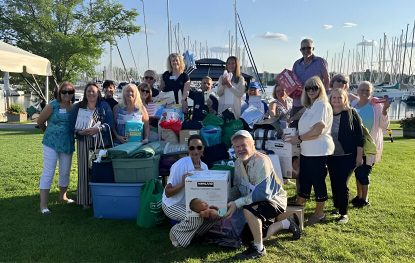 On behalf of St. Vincent and The Grenadines, Shelley John, Director of Sales, Canada accepts generous donations from The Bob Family Travel Team at TravelOnly, lead by Pat Probert and Mary de Almeida